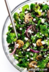 Zesty Lentil Spinach Salad recipe card image, showing a vibrant bowl of salad with fresh ingredients and a lemon wedge.
