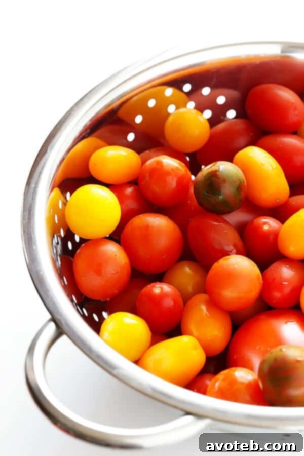 Speedy Summer Gazpacho 4 A close-up shot of various ripe tomatoes in a bowl, ready to be transformed into a refreshing gazpacho, highlighting their vibrant colors and freshness.