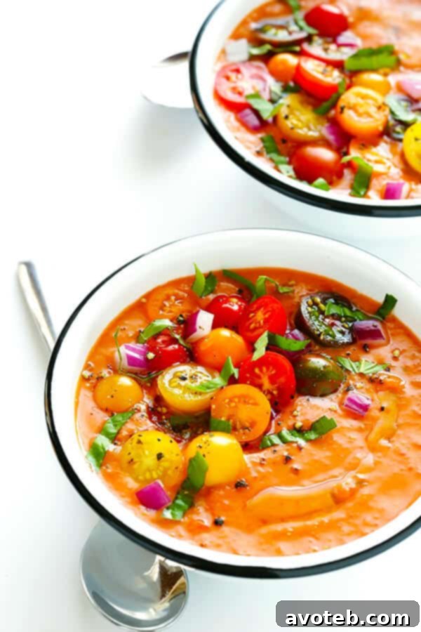 Speedy Summer Gazpacho 7 Freshly blended gazpacho in a clear glass bowl, showcasing its smooth texture and vibrant red color, ready to be chilled and served.