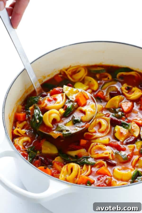 Comforting Tortellini Minestrone 3 Close-up of the delicious Tortellini Minestrone, showcasing the tender tortellini and various chopped vegetables in a savory broth.