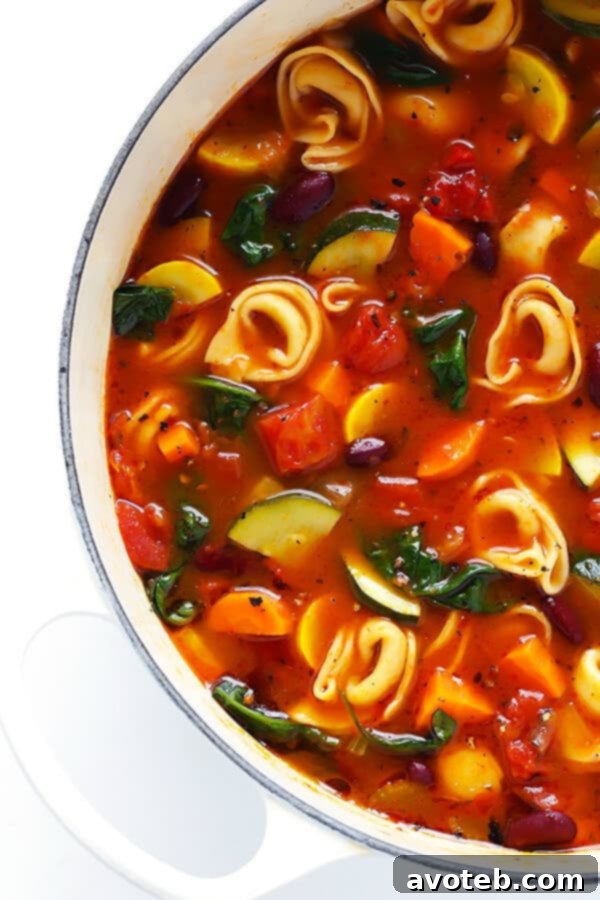Comforting Tortellini Minestrone 4 A vibrant bowl of Minestrone soup, featuring fresh vegetables like zucchini and kidney beans, ready for the tortellini addition.