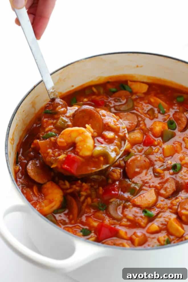 Ingredients for Jambalaya Soup laid out, including chicken, sausage, shrimp, and fresh vegetables