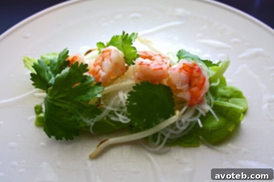 Close-up of a neatly rolled Vietnamese spring roll, ready to be sliced.