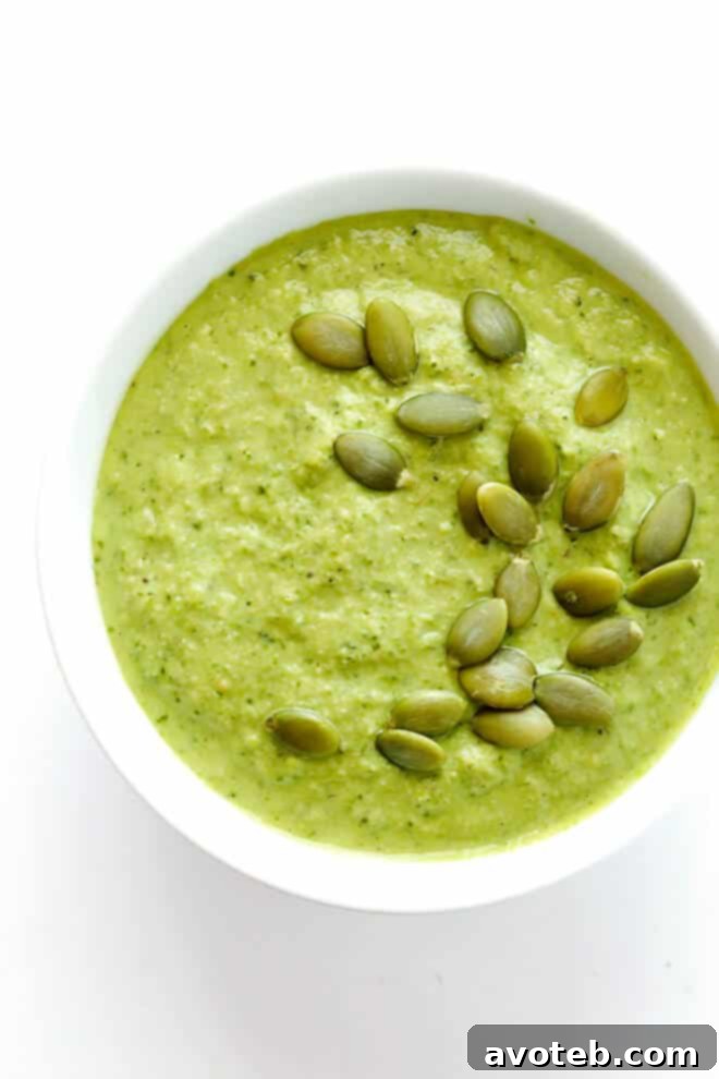 Vibrant green pumpkin seed sauce (Pepián Verde) in a bowl, ready to be served with chicken.