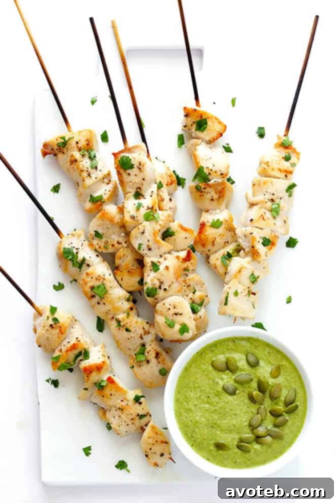 Chicken skewers drizzled with the homemade Pepita Sauce, presented as a delicious and easy meal.