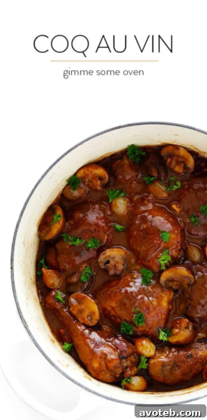 A large serving pot filled with Coq Au Vin, ready to be served, showing the tender chicken and rich sauce.