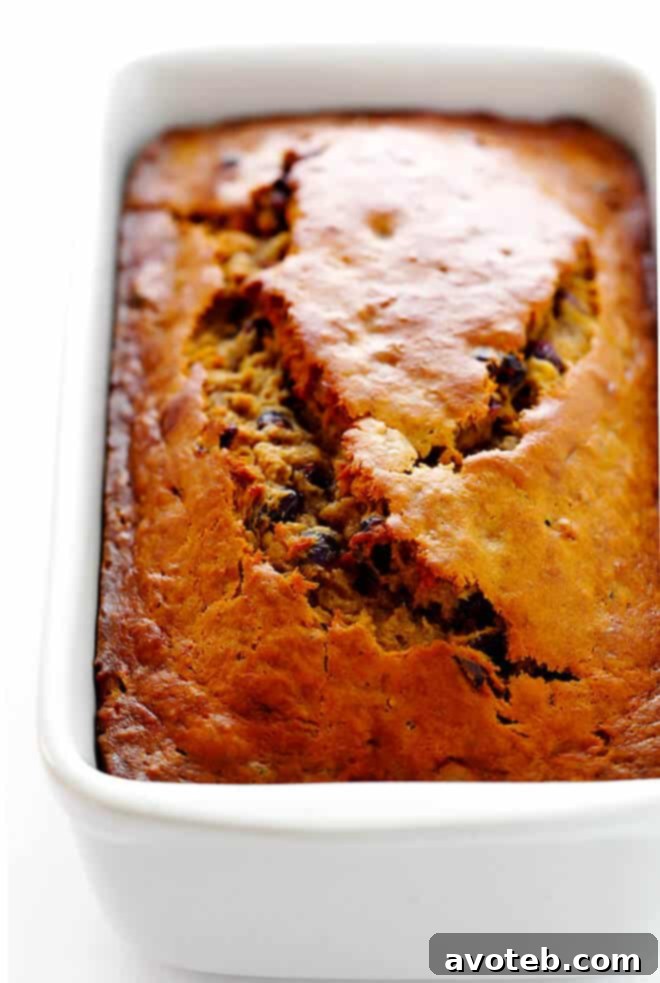 A freshly baked loaf of Cranberry Orange Banana Bread, golden brown and perfectly risen.