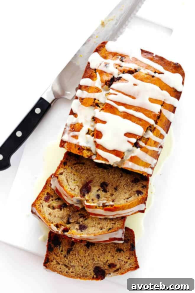 Several slices of Cranberry Orange Banana Bread beautifully arranged, showcasing the moist texture and cranberry pieces.