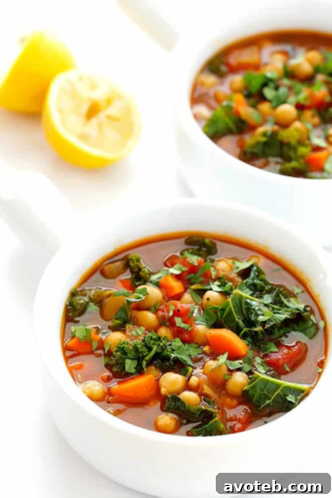 A beautifully garnished bowl of 20-Minute Moroccan Chickpea Soup with cilantro and lemon