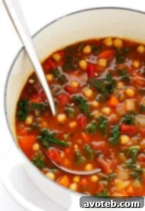 A vibrant bowl of 20-Minute Moroccan Chickpea Soup, garnished with fresh cilantro and a lemon wedge.
