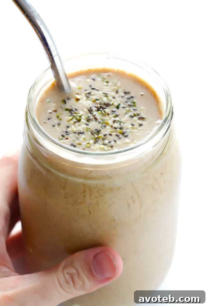 Smooth and creamy Coffee Protein Smoothie poured into a glass, garnished lightly