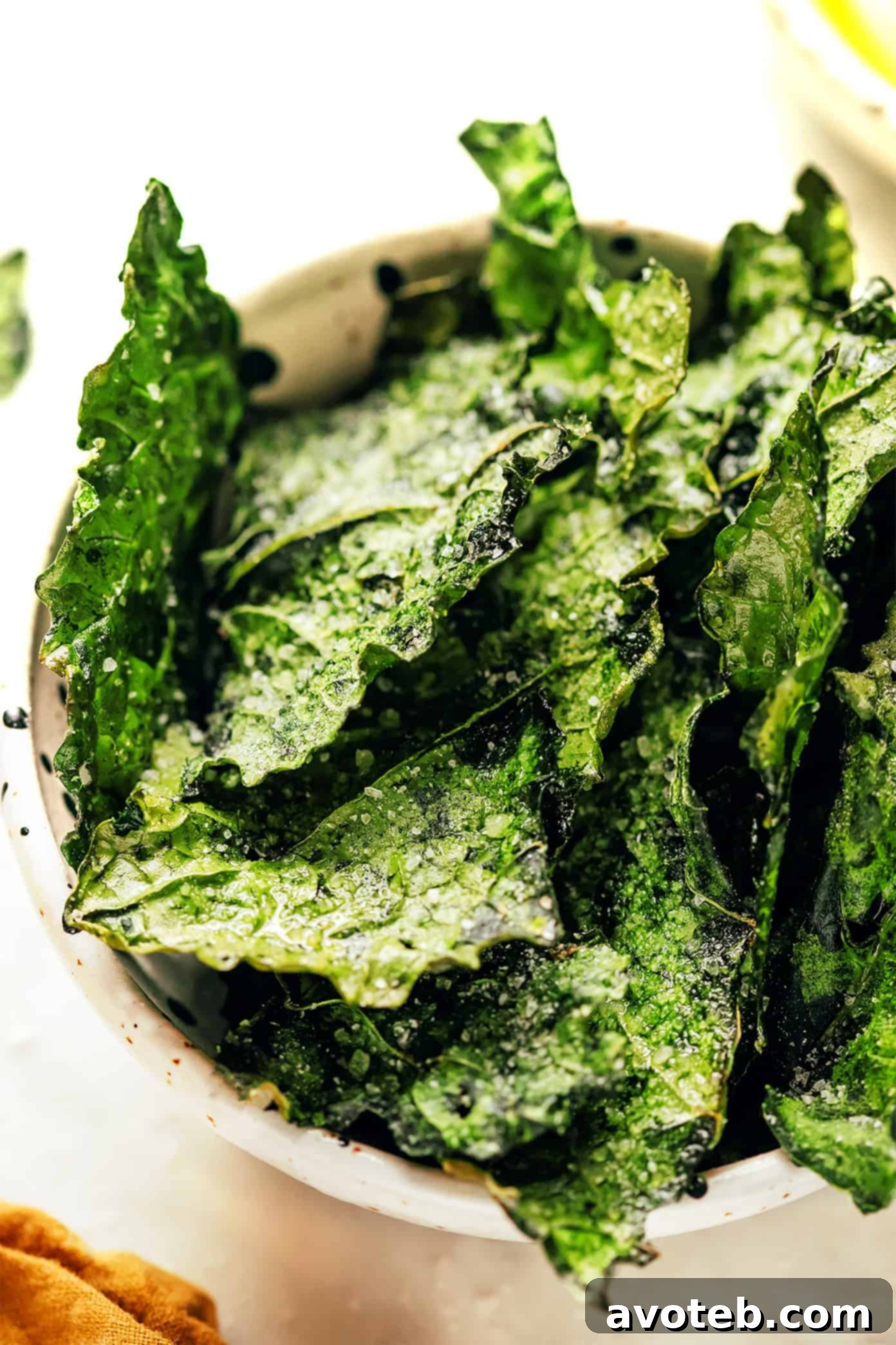 Various seasoned kale chips displayed in small bowls, highlighting different flavor options.