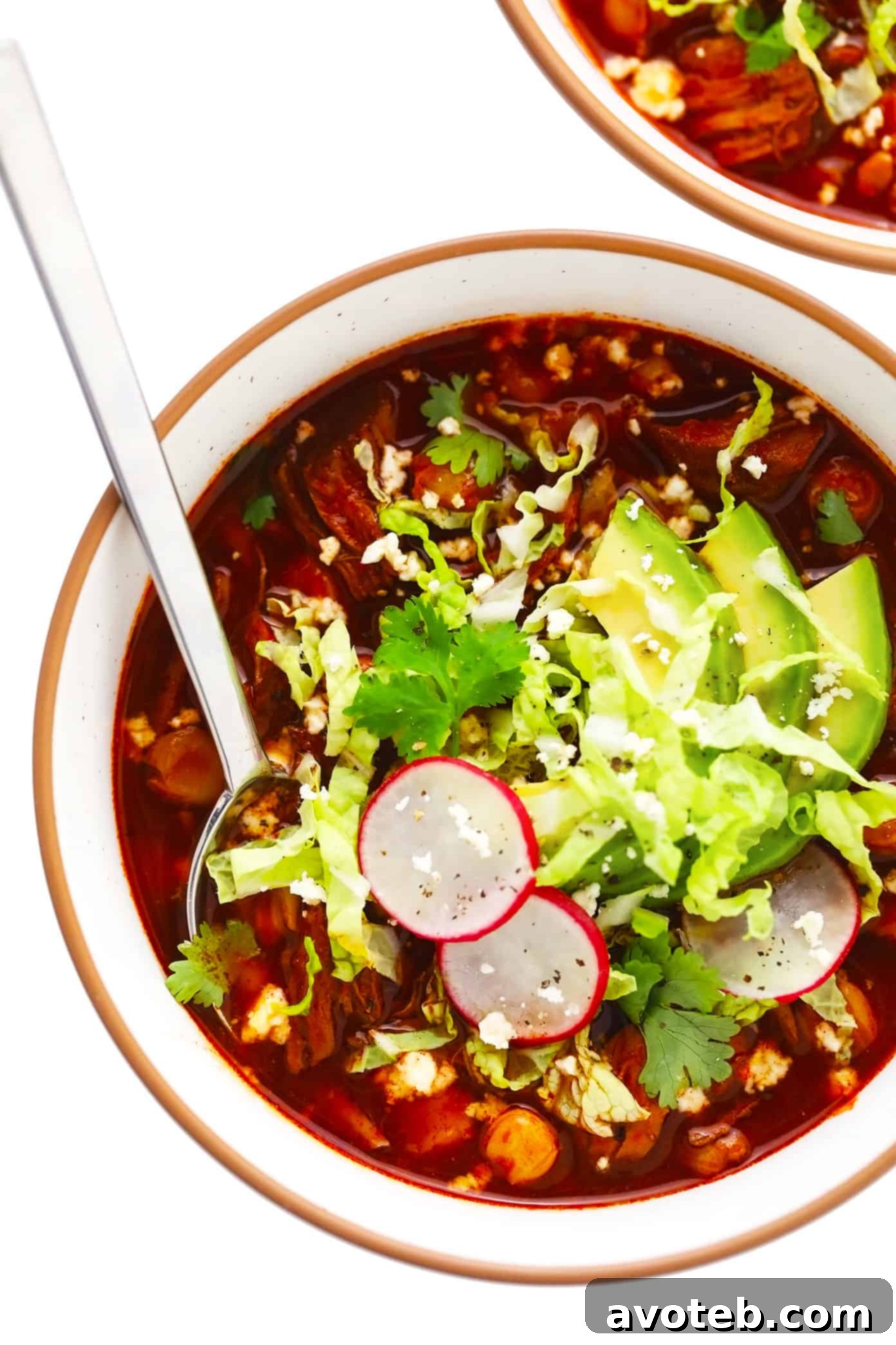 Authentic Pork Pozole Rojo A vibrant bowl of Pozole Rojo, showcasing the rich red broth, tender pork, and hominy, garnished with fresh cilantro and lime, ready to be enjoyed as a comforting Mexican stew.