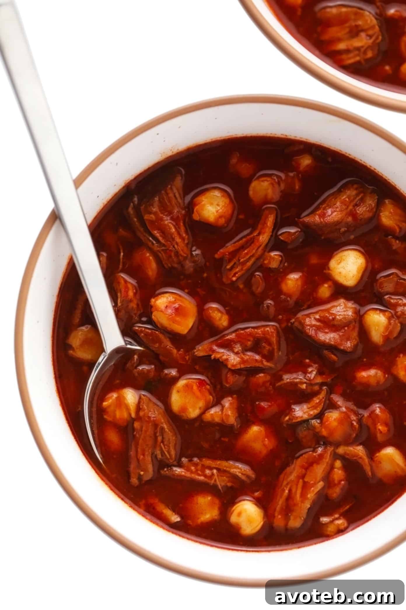Plain Bowl of Pozole Rojo A simple serving bowl of red pozole, without any toppings, ready for customization with fresh garnishes.