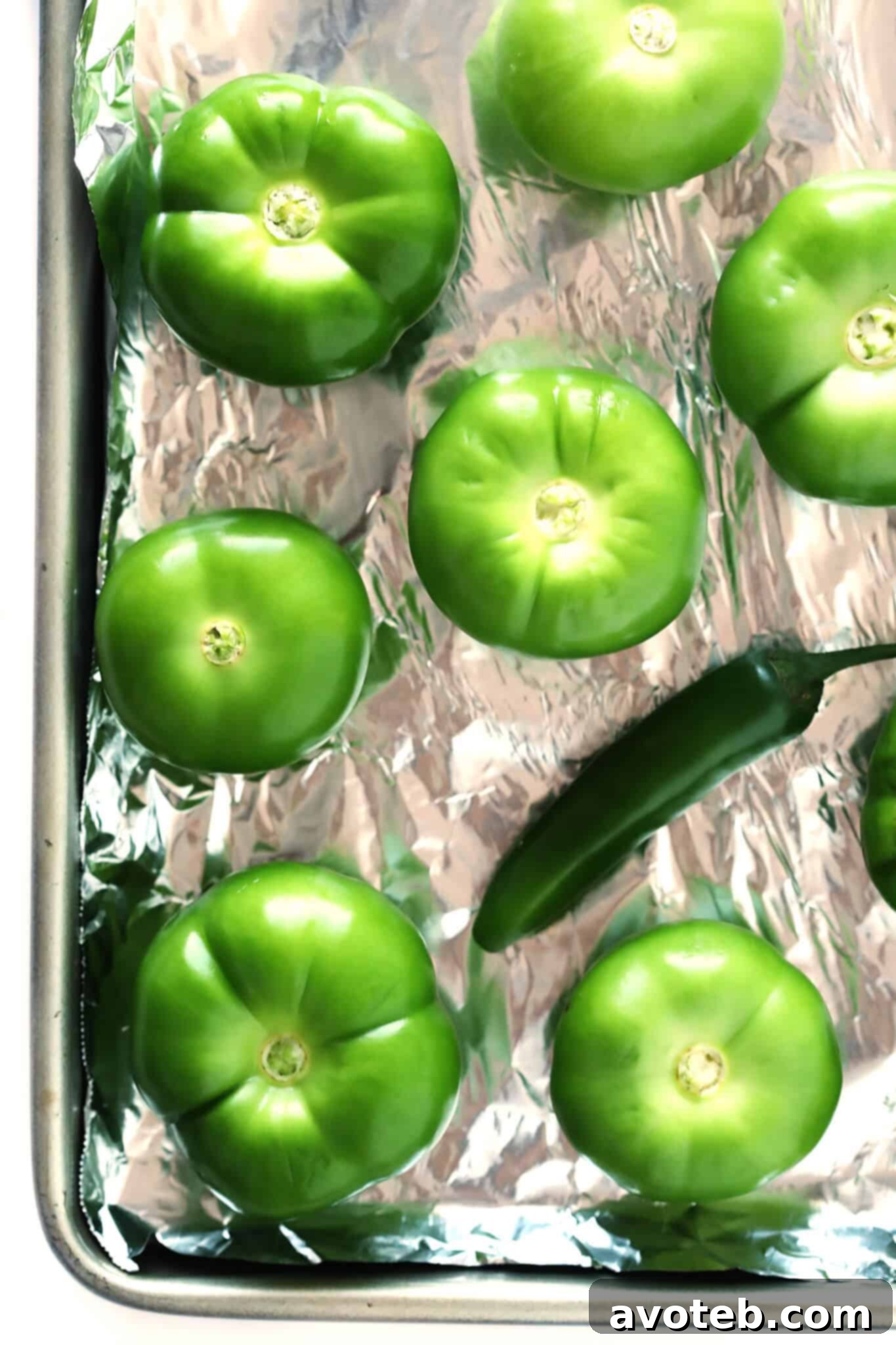 Freshly made green salsa, showcasing its vibrant color and smooth texture, in a white bowl.