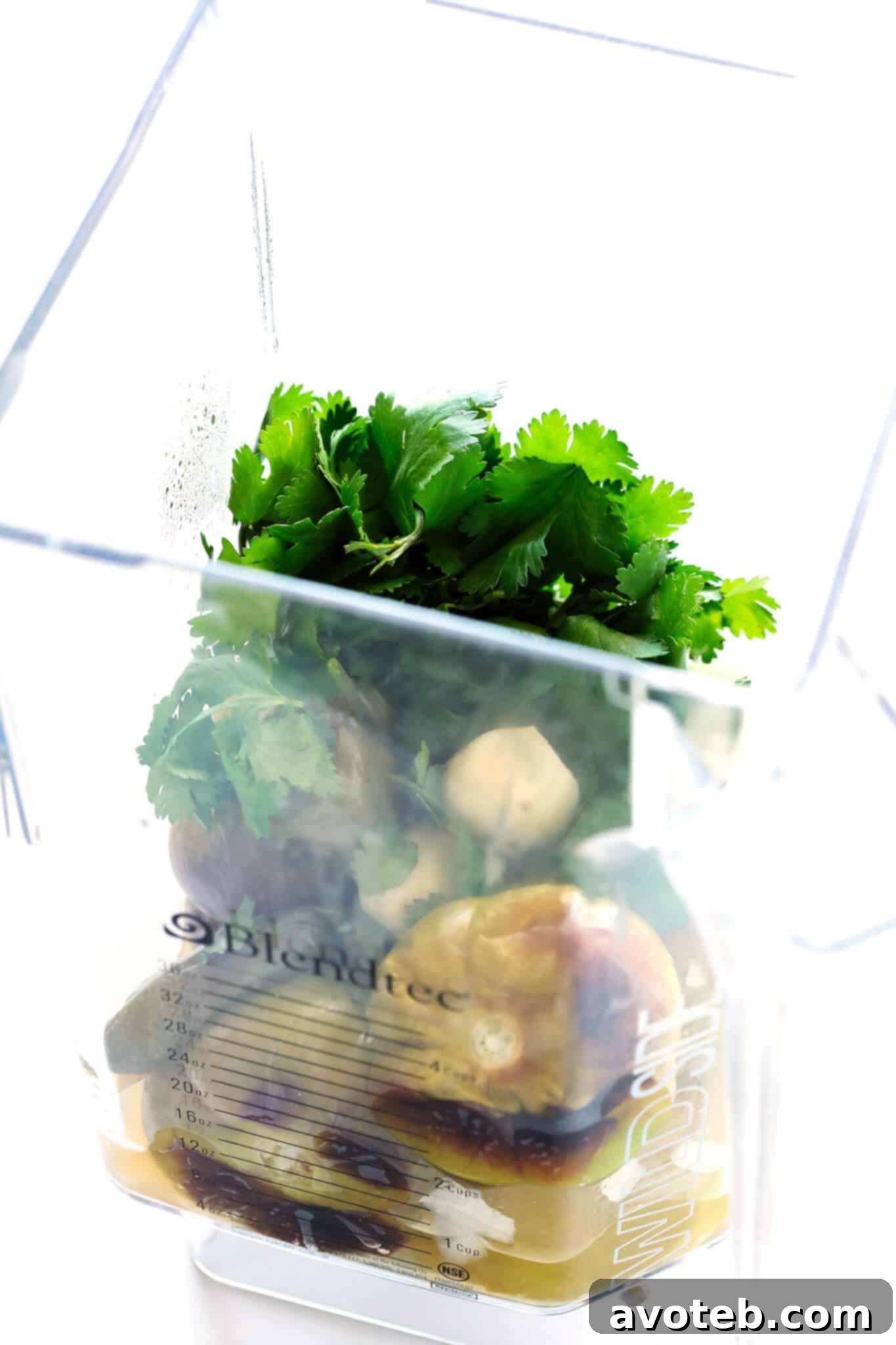 A bowl of homemade salsa verde, garnished with fresh cilantro, served with tortilla chips.