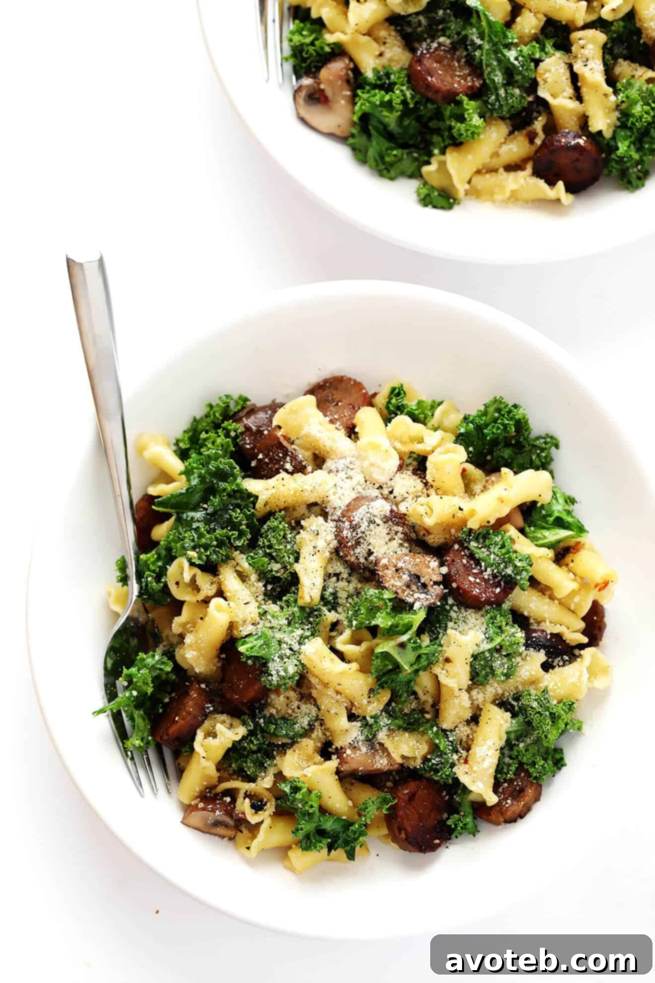 Overhead shot of the finished Pasta with Italian Sausage, Mushrooms, and Kale, garnished and ready for serving.