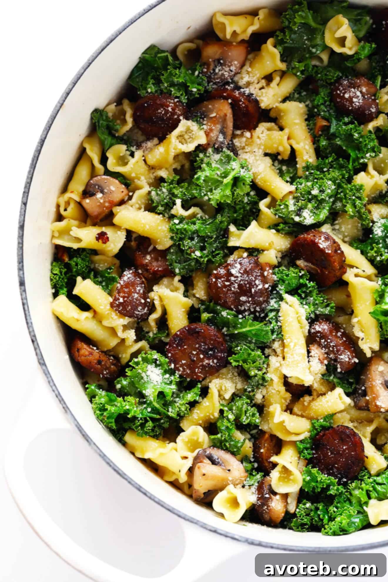 A close-up, appetizing view of a serving of Pasta with Italian Sausage, Mushrooms, and Kale in a bowl.