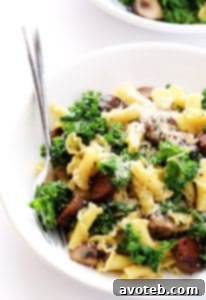 A vibrant and savory pasta dish featuring Italian sausage, earthy mushrooms, and healthy kale.