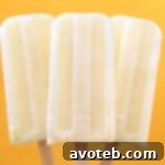 Close-up of a creamy lemon popsicle, inviting and refreshing.
