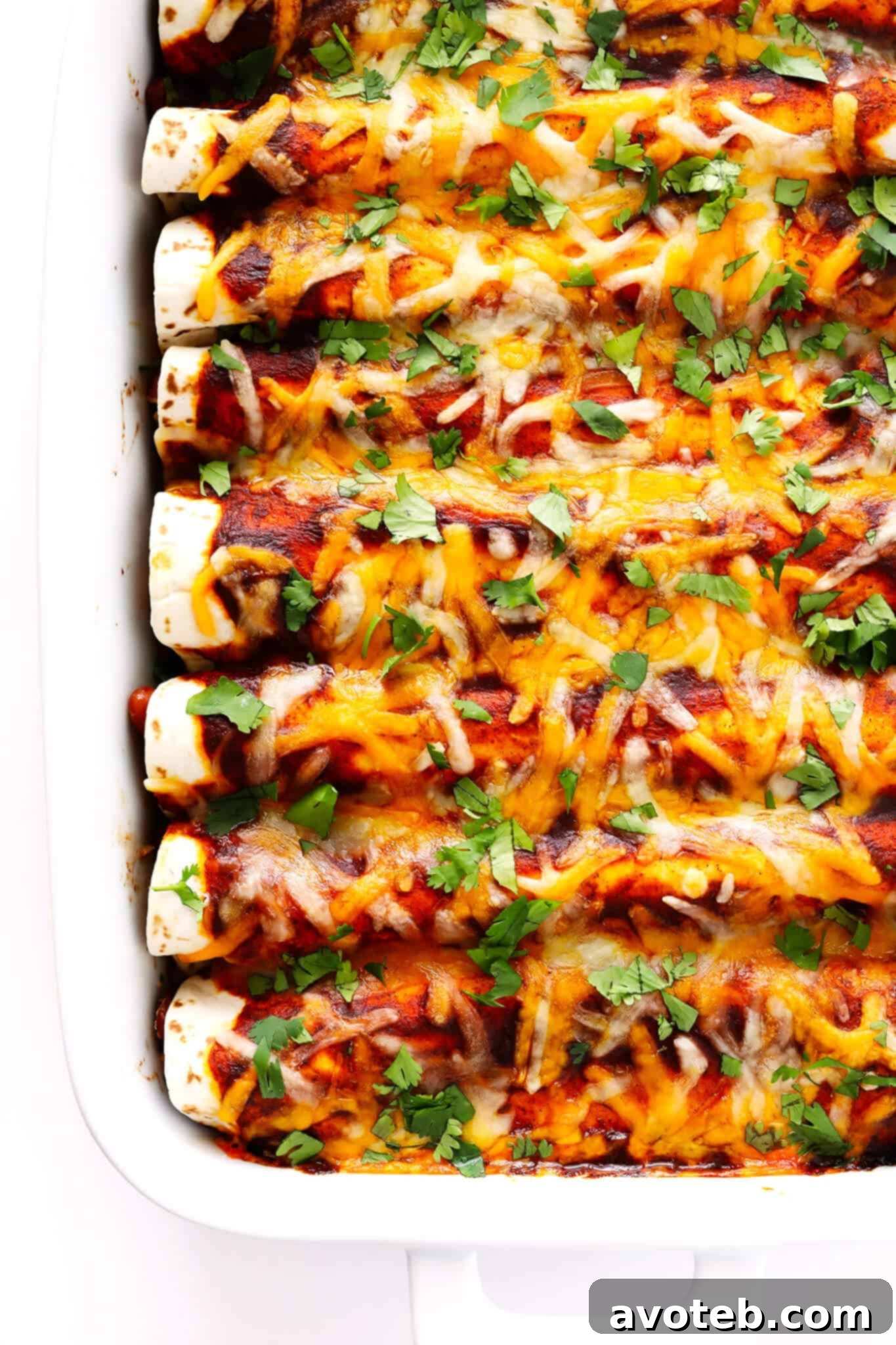Delicious Ancho Chicken Enchiladas, featuring tender chicken and beans wrapped in tortillas, smothered in homemade sauce and melted cheese. A perfect dish for Mexican food lovers.
