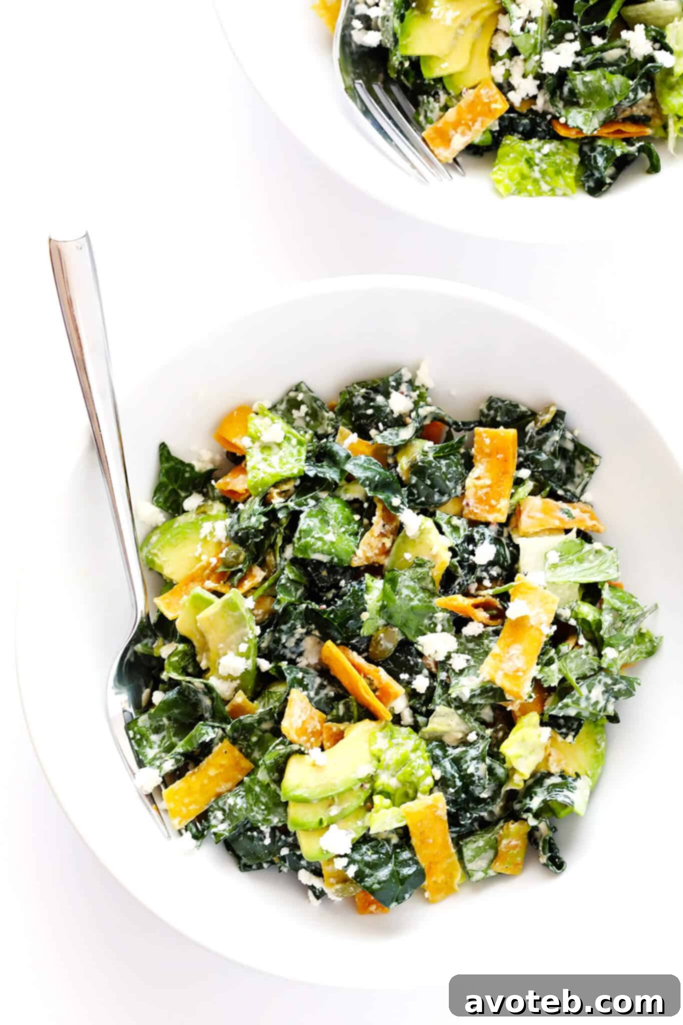 The BEST Mexican Caesar Salad recipe! Loaded with avocado, crispy tortilla chips, kale, pepitas, queso fresco, and a delicious Greek Yogurt Lime Caesar Dressing. You'll love it!