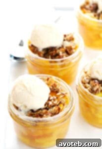 Mini Fruit Crisps in ramekins, topped with oatmeal crisp and a scoop of ice cream.