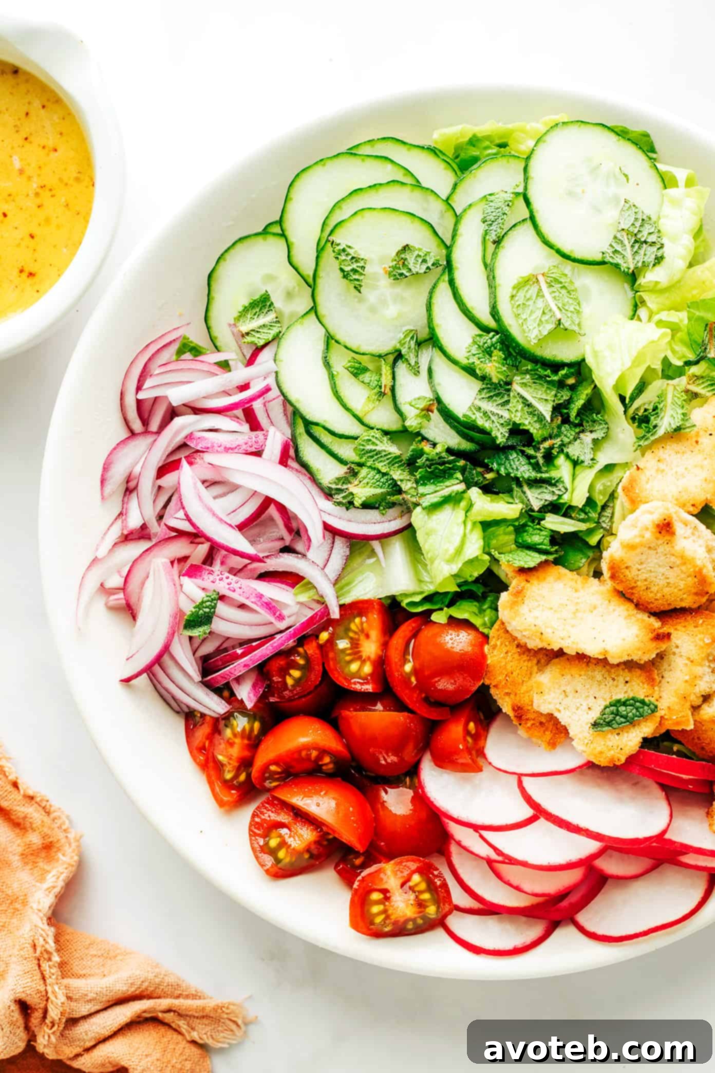 Fattoush salad served in a white bowl, ready to eat
