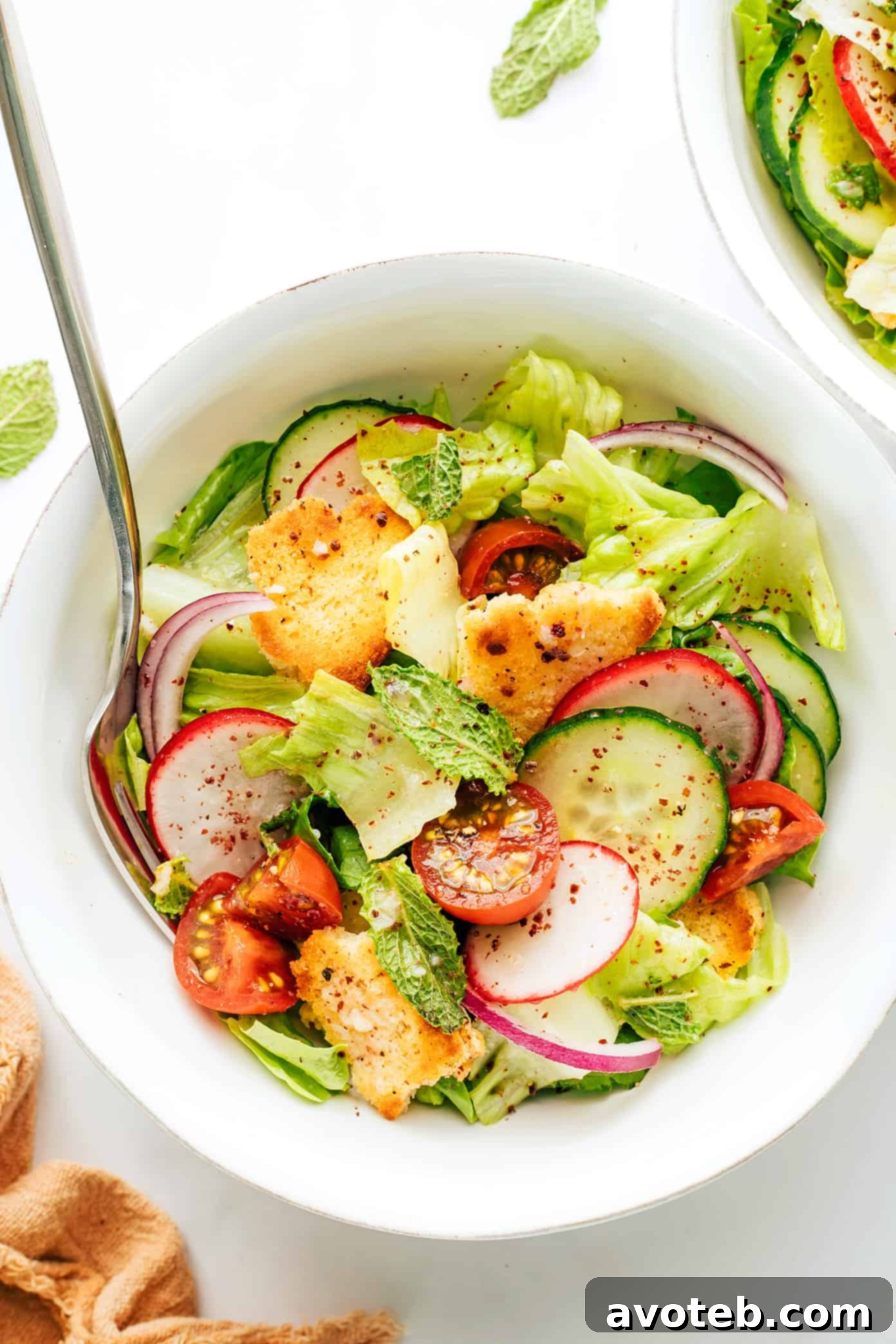 Fattoush salad with a full spread of ingredients on a wooden table