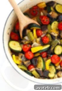 No-Fuss Ratatouille 2 A colorful bowl of easy ratatouille with a crusty baguette slice.