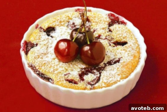 Delicious Cherry Clafoutis with fresh cherries and powdered sugar
