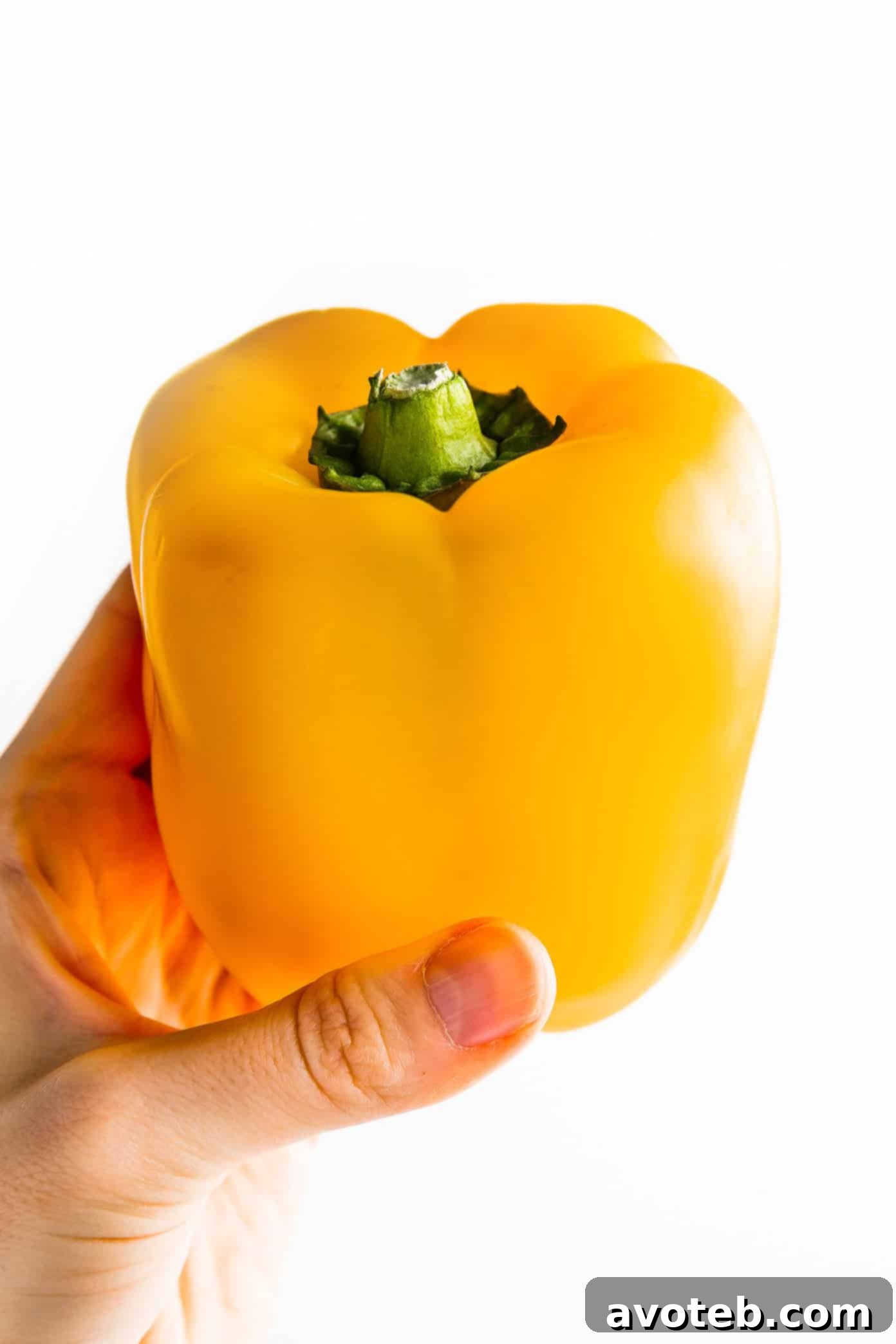Cut Bell Peppers Like a Pro 4 A selection of colorful bell peppers displayed on a rustic wooden table.