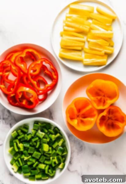 A whole red bell pepper alongside neatly cut slices and dices, ready for cooking.