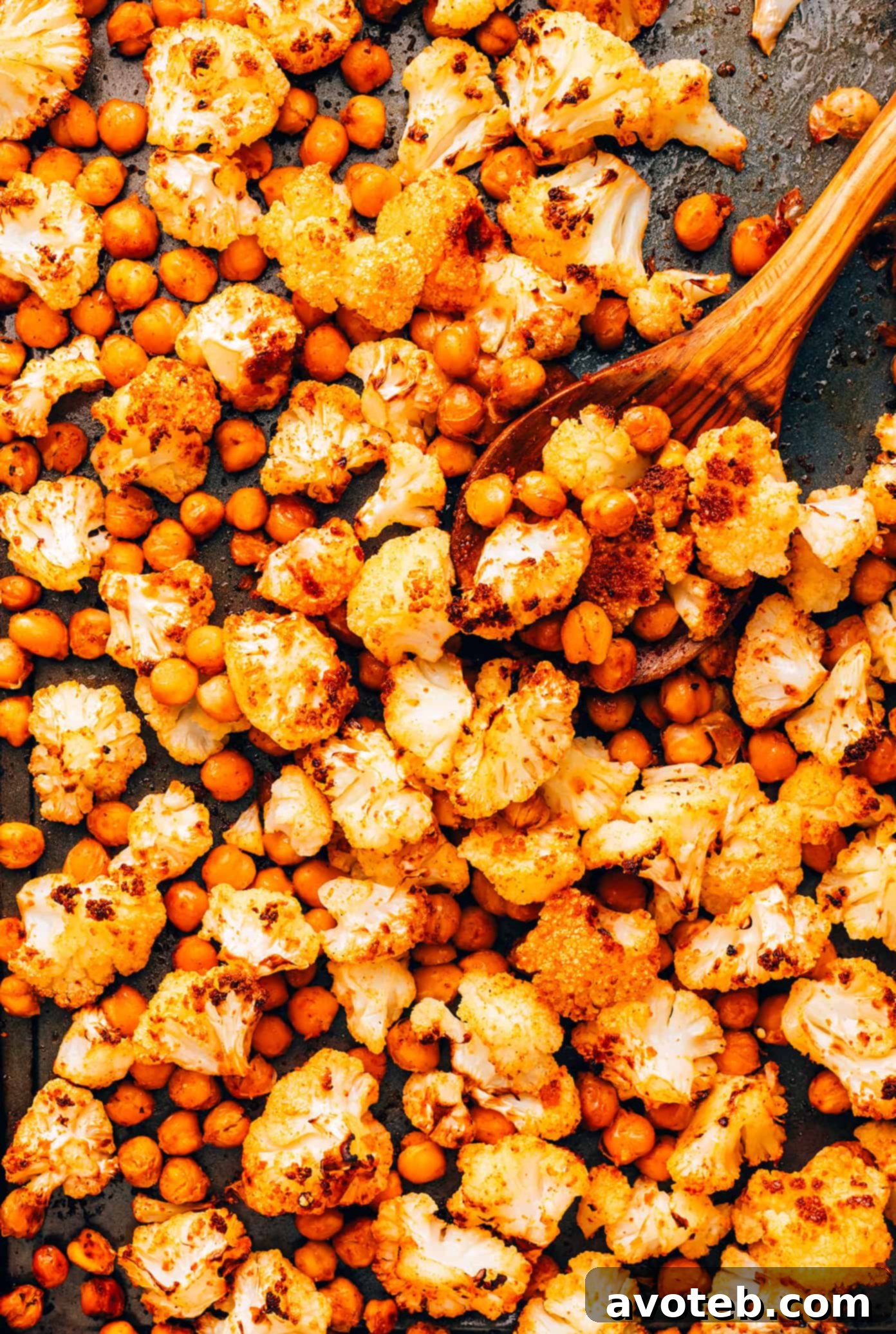 A close-up shot of the Roasted Cauliflower, Chickpea, and Arugula Salad in a bowl, showing the texture and colors of the ingredients.