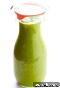 Avocado Cilantro Dressing in a small bowl, garnished with fresh cilantro.