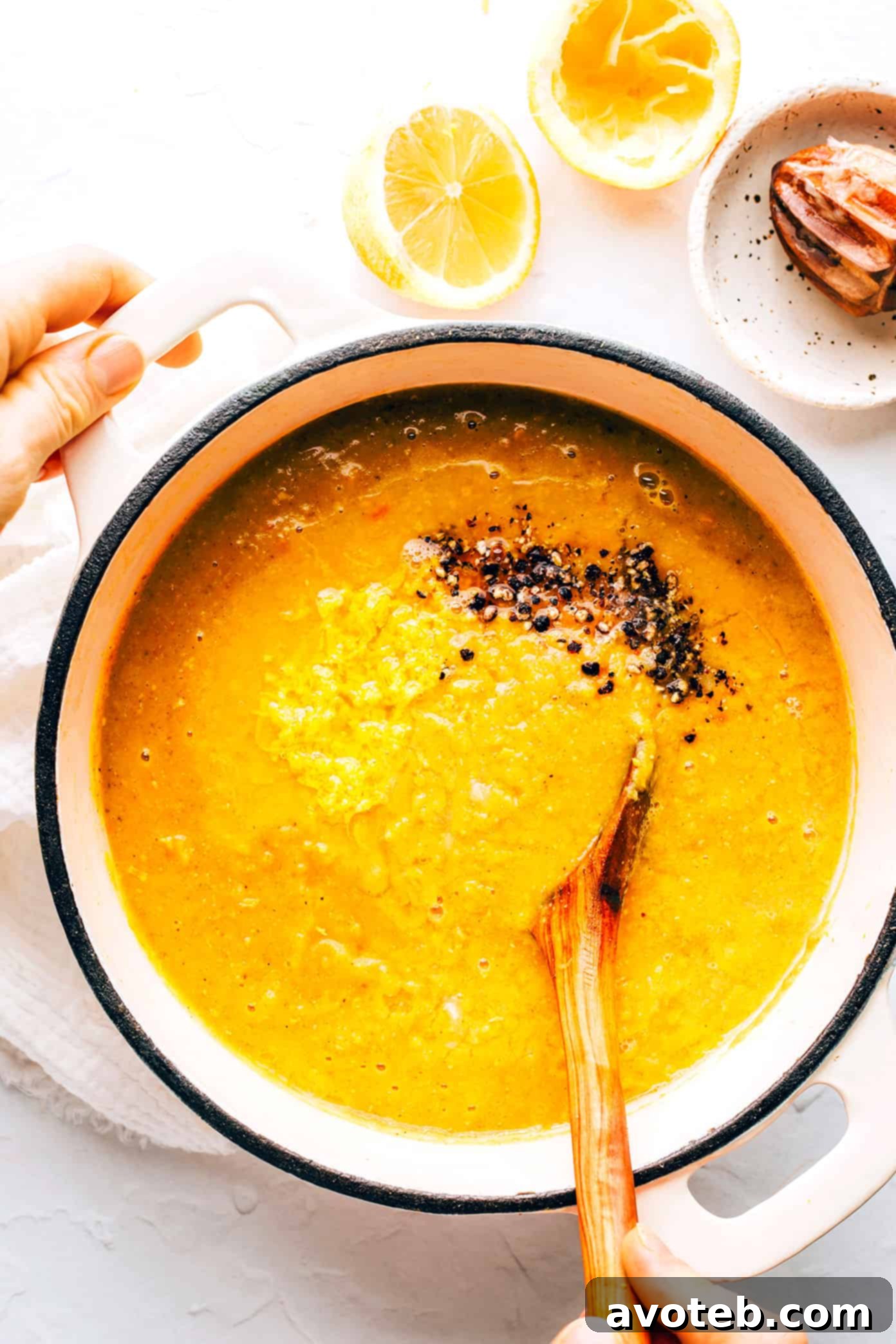 Lemony Red Lentil Soup simmering in a large pot on the stovetop, ready to be served.