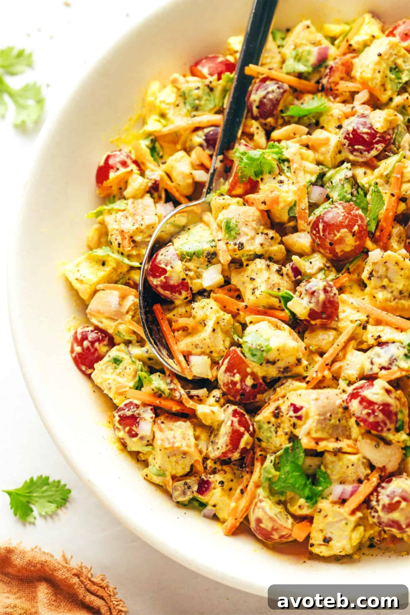 Curry Chicken Salad featuring diced chicken, grapes, carrots, cashews, red onions, and a creamy Greek yogurt curry sauce.