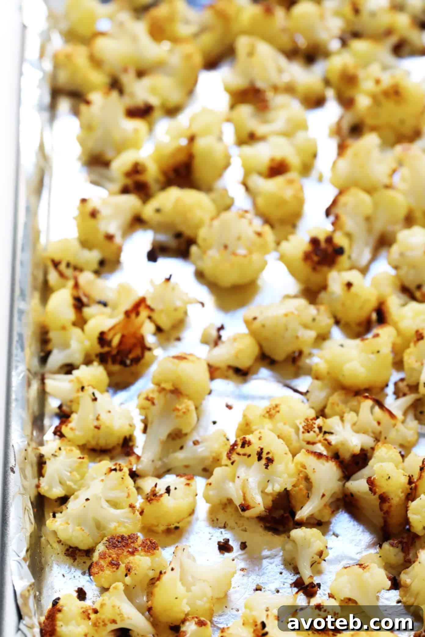 Close-up of roasted cauliflower florets, the base for the vegetarian buffalo dip, showcasing their slight char.