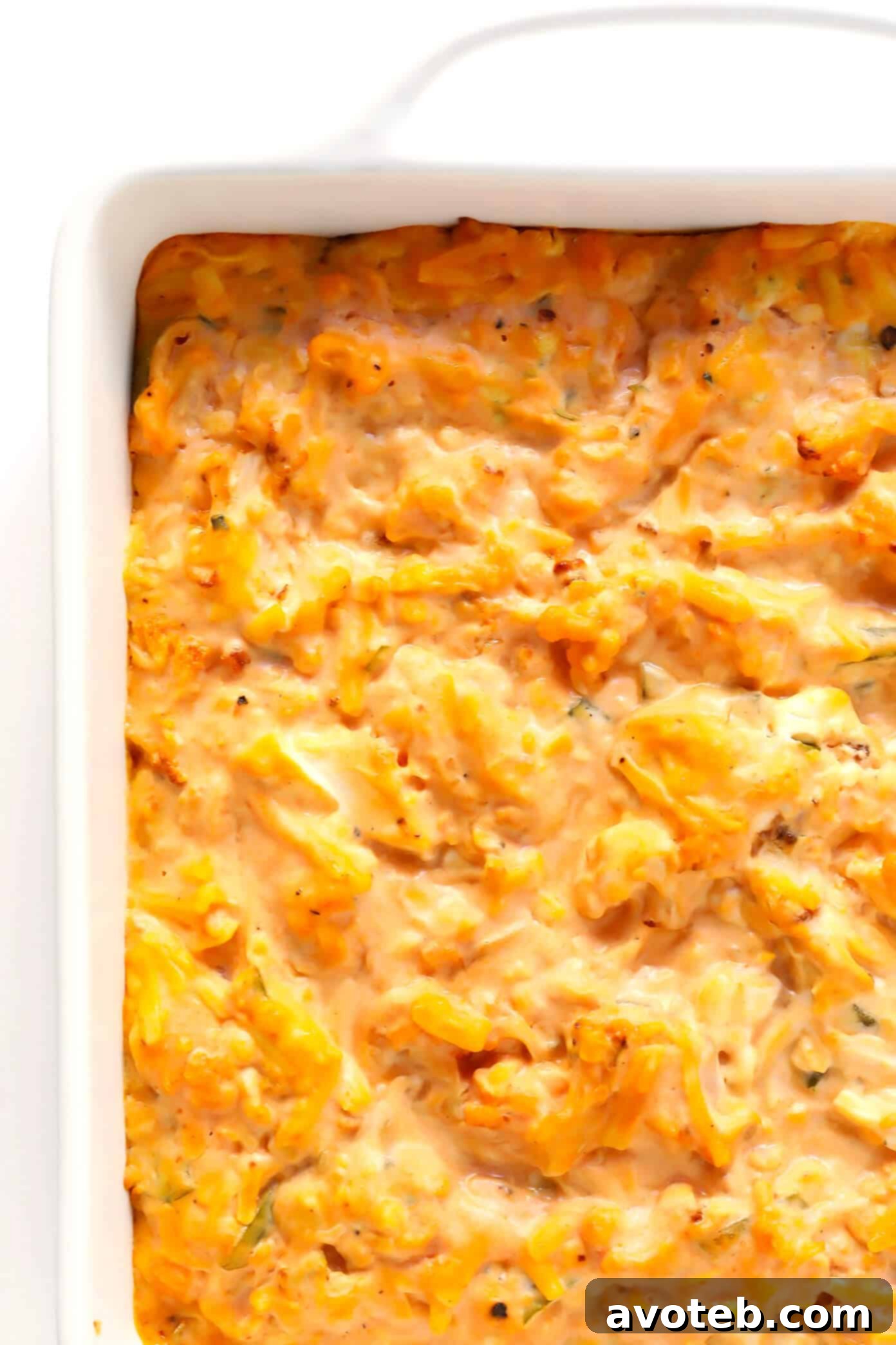 Golden brown Buffalo Cauliflower Dip baked to perfection in a square dish, ready to be served.