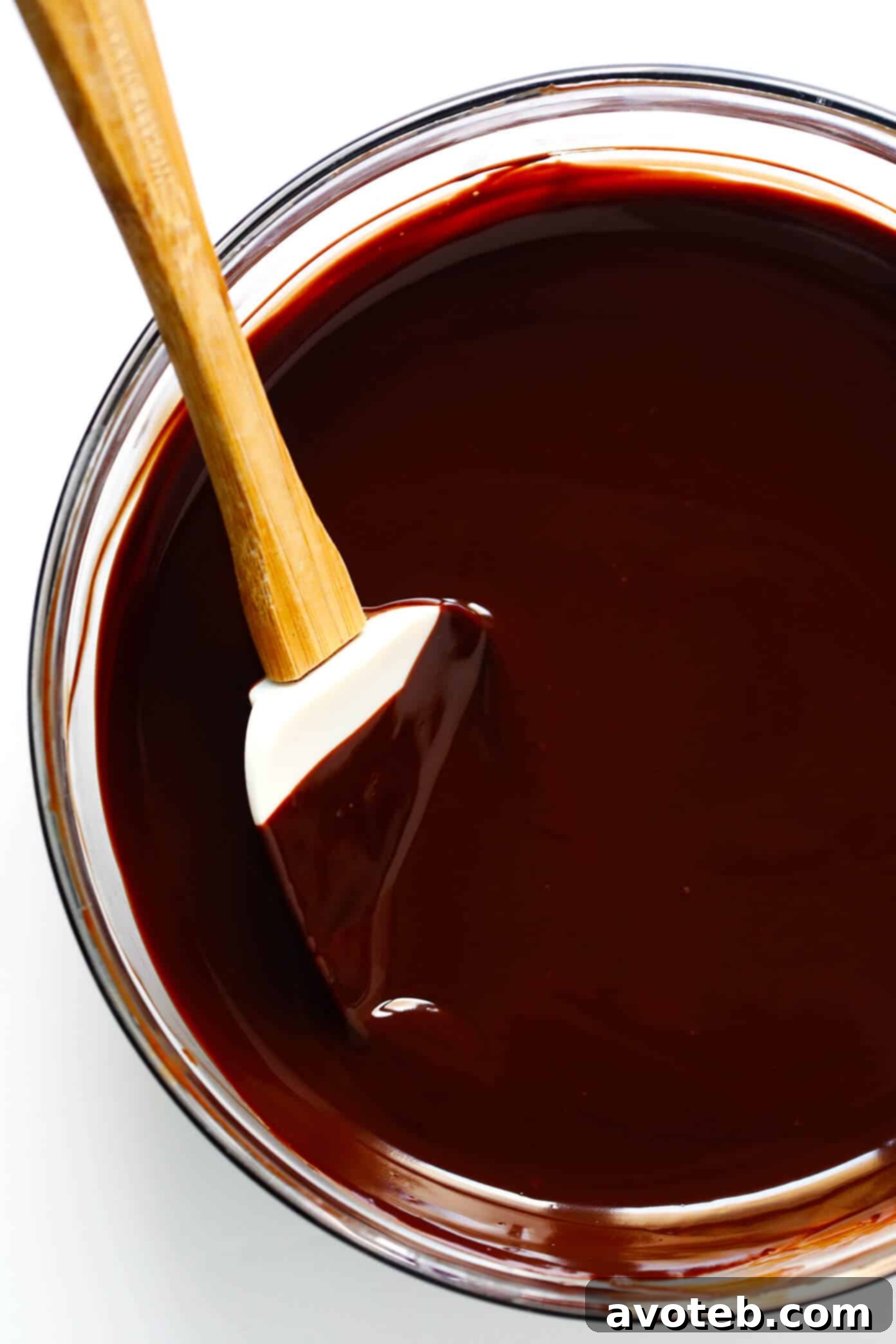 Luxurious melted dark chocolate filling, glossy and smooth in a glass bowl, ready to be poured.