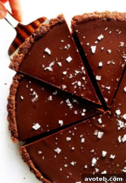 The Most Amazing Salted Dark Chocolate Tart, elegantly presented.