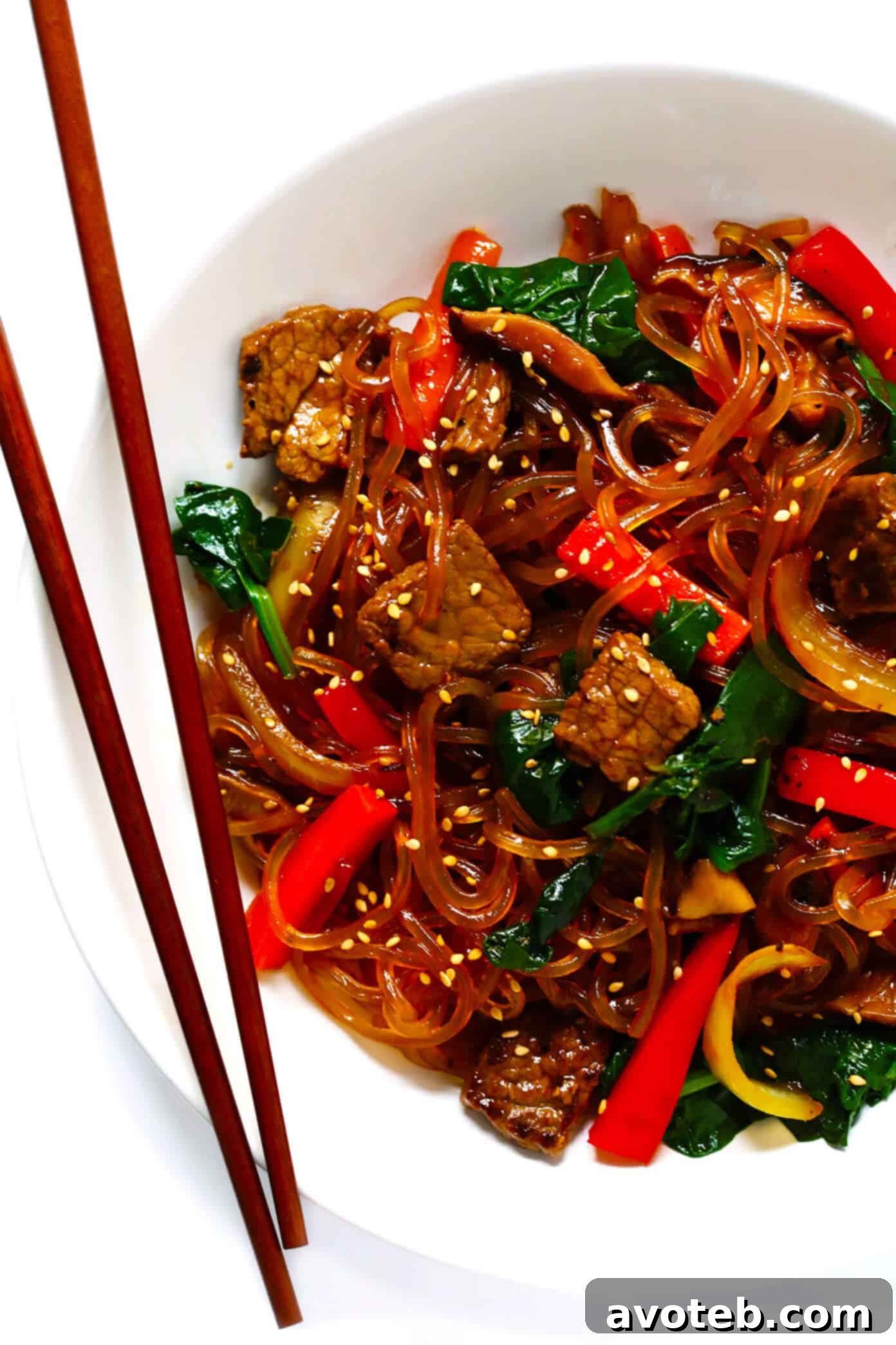 This Japchae (Korean noodle stir-fry) recipe is easy to make in just 30 minutes. It can be customized with your choice of veggies and protein (beef, chicken, shrimp, or tofu). And it is SO delicious! | gimmesomeoven.com #korean #noodle #stirfry #saute #pasta #beef #glutenfree #vegetarian #vegan #asian #dinner #mealprep #healthy Japchae Korean Noodle Stir Fry - A vibrant and delicious quick dinner option
