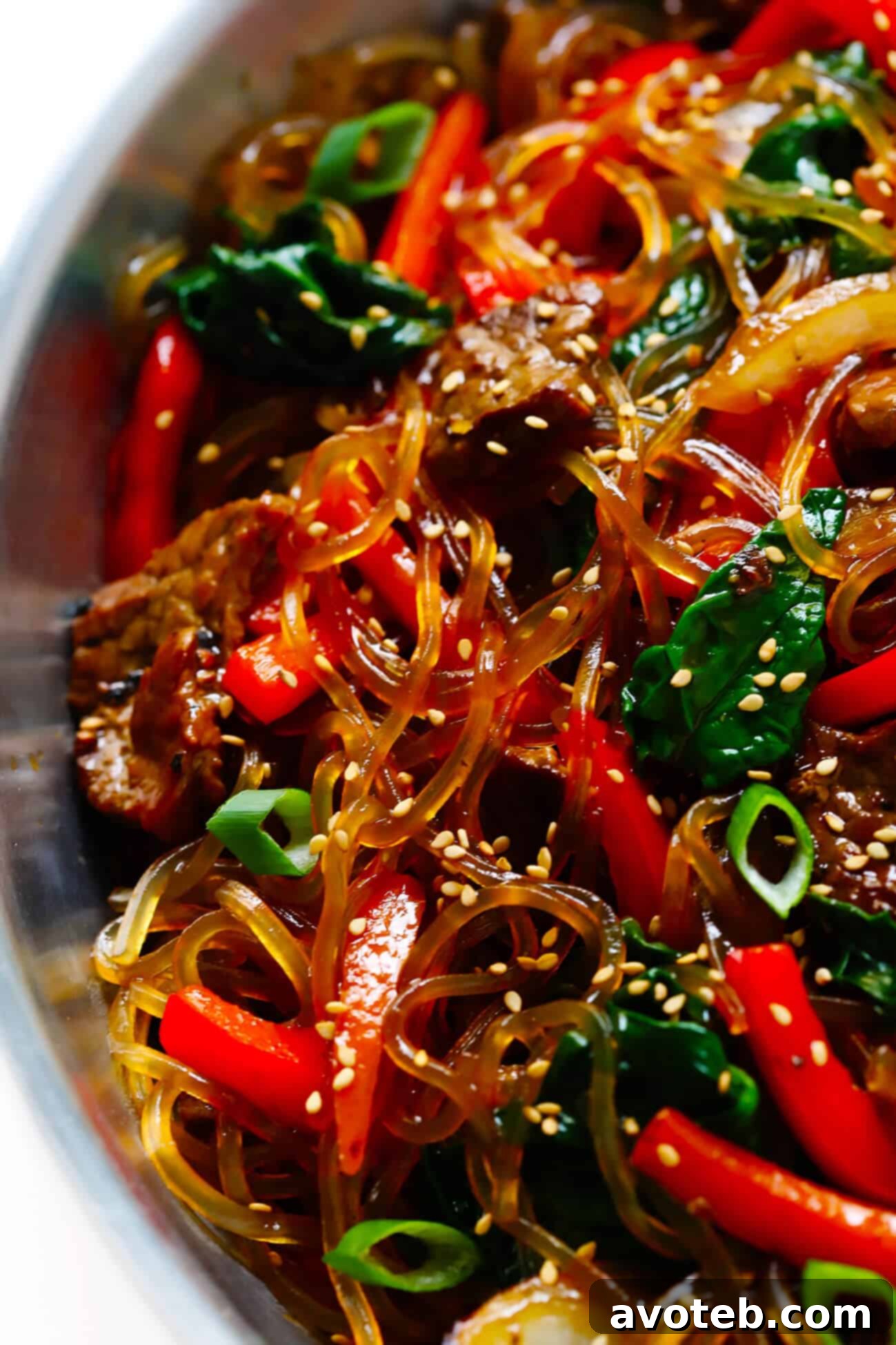 This Japchae (Korean noodle stir-fry) recipe is easy to make in just 30 minutes. It can be customized with your choice of veggies and protein (beef, chicken, shrimp, or tofu). And it is SO delicious! | gimmesomeoven.com #korean #noodle #stirfry #saute #pasta #beef #glutenfree #vegetarian #vegan #asian #dinner #mealprep #healthy Korean noodles Japchae recipe with delicious beef and fresh vegetables