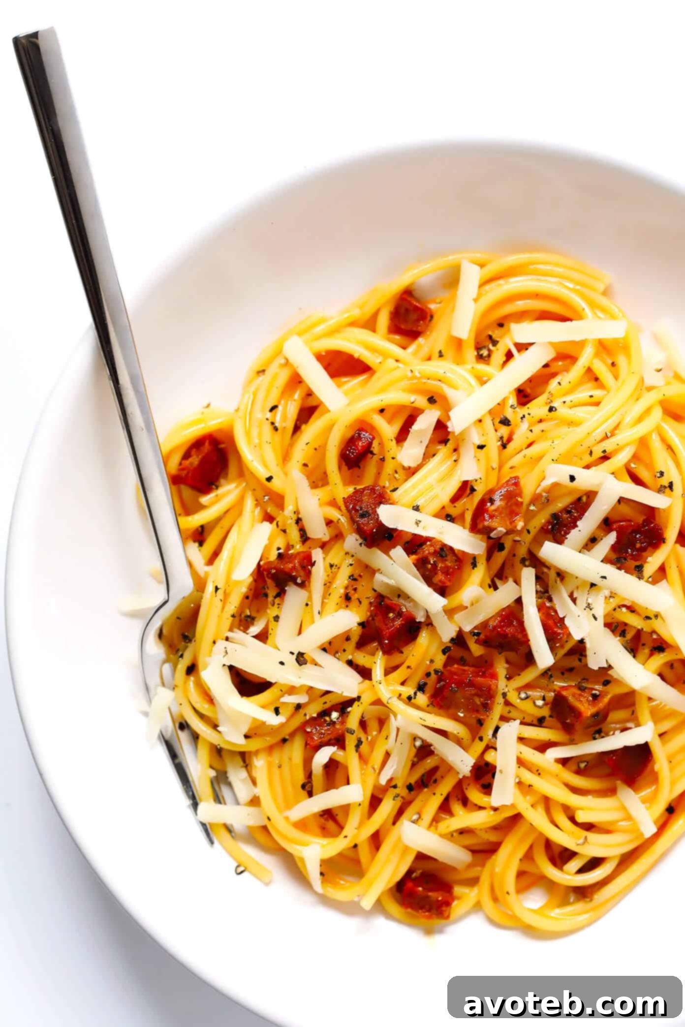 A plate of Spanish Chorizo Spaghetti Carbonara, showcasing the rich colors and textures. A full serving of Spanish Chorizo Spaghetti Carbonara on a plate, garnished with fresh herbs and a sprinkle of cheese.