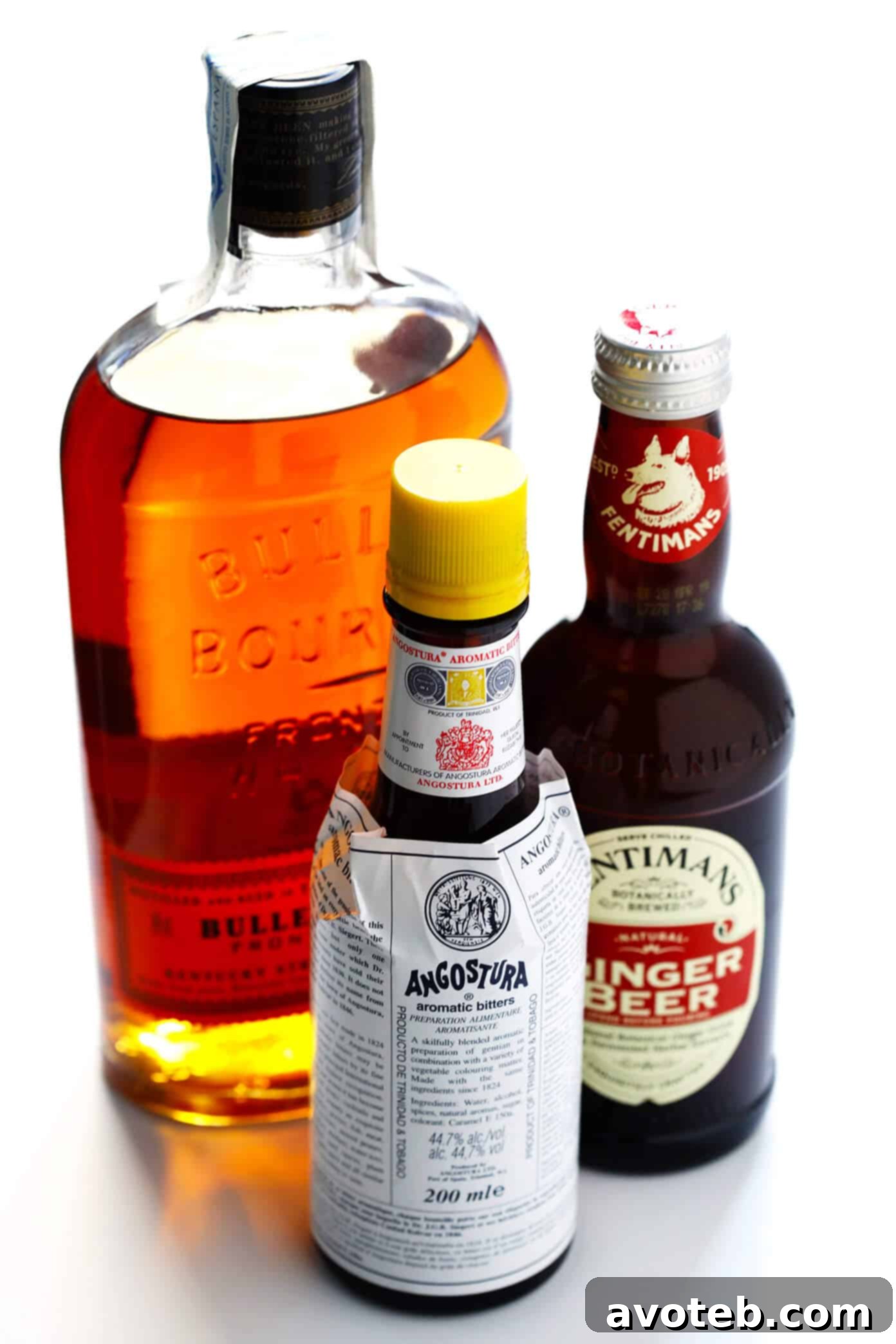 Key ingredients for a Horsefeather Cocktail: bourbon whiskey, Angostura bitters, and ginger beer.