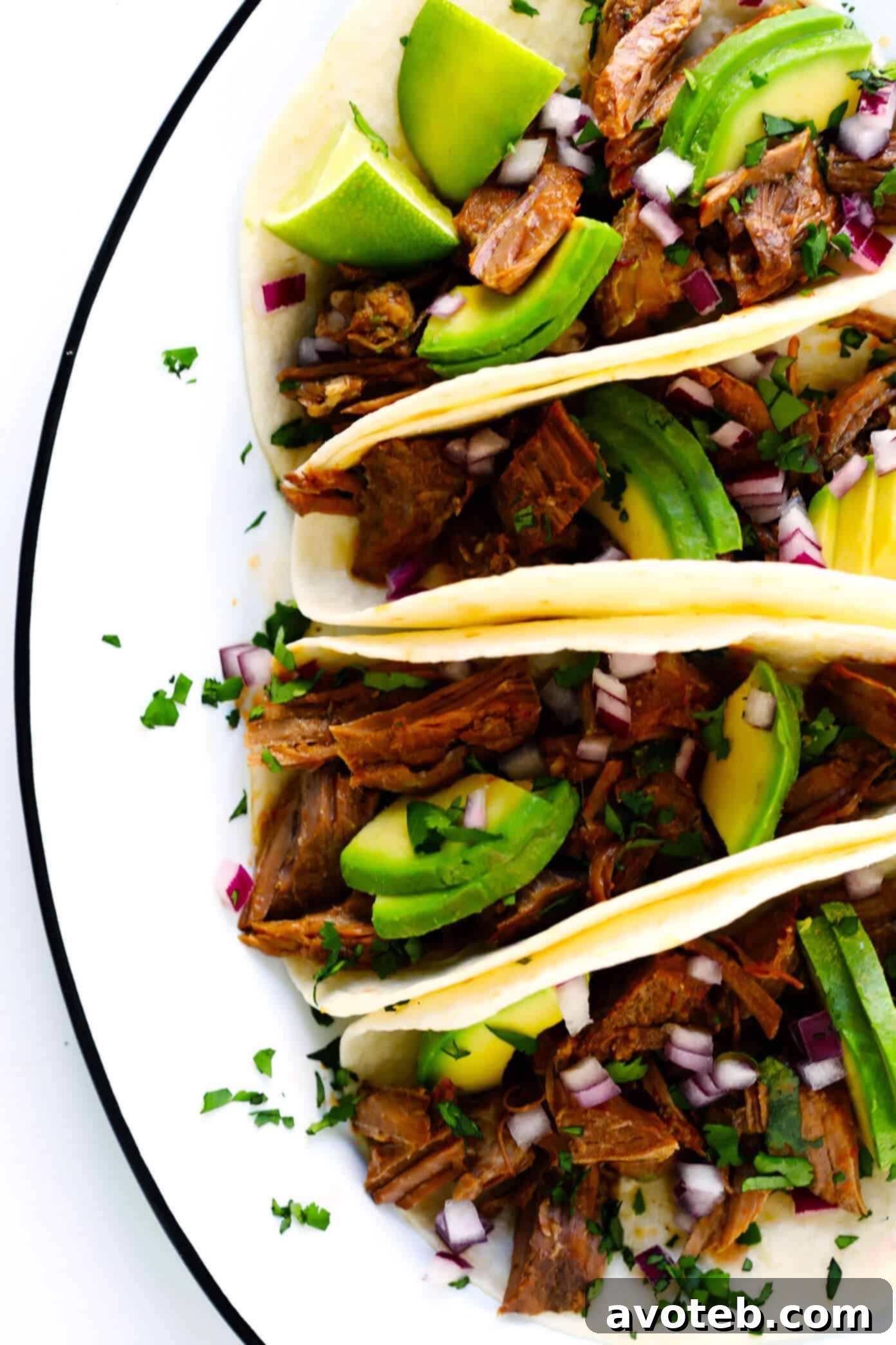 Instant Pot Barbacoa Beef Tacos served with fresh avocado and cilantro