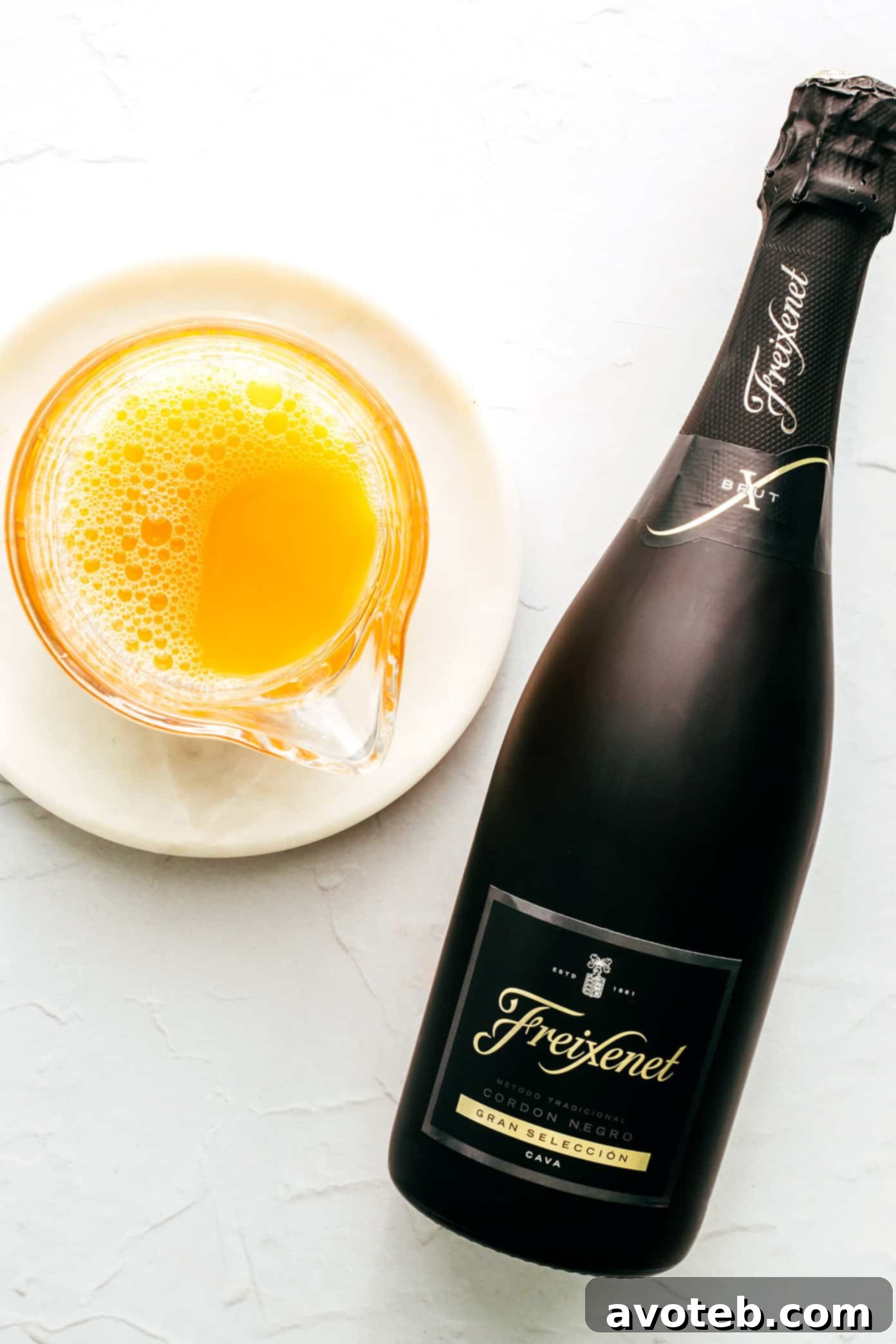 Mimosa Sunshine 3 Ingredients for Mimosas laid out with sparkling wine and orange juice