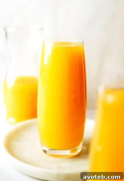 Classic Mimosa served in a champagne flute with orange garnish