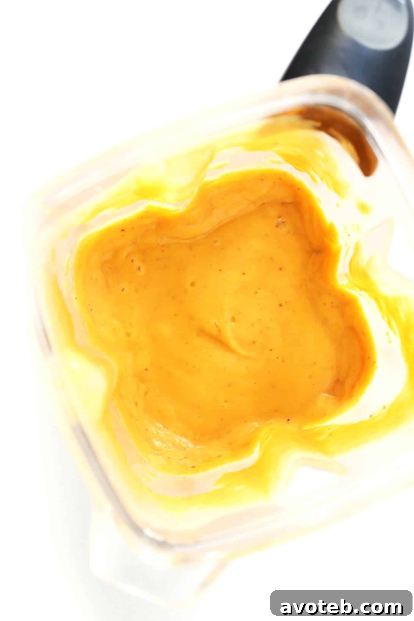 Blender with ingredients for red curry sauce being prepared