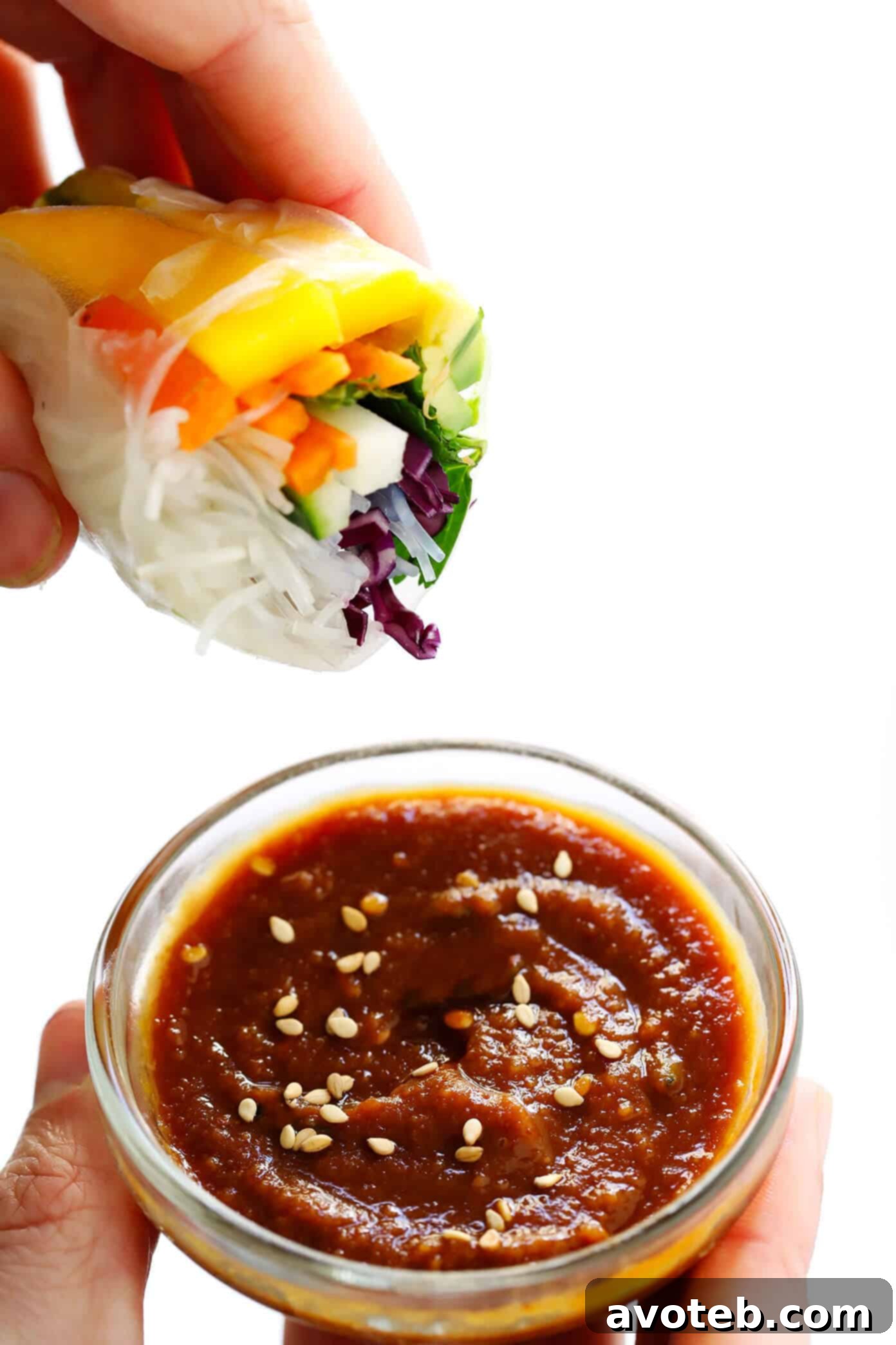 Easy Mango Avocado Spring Rolls dipped in a delicious peanut sauce